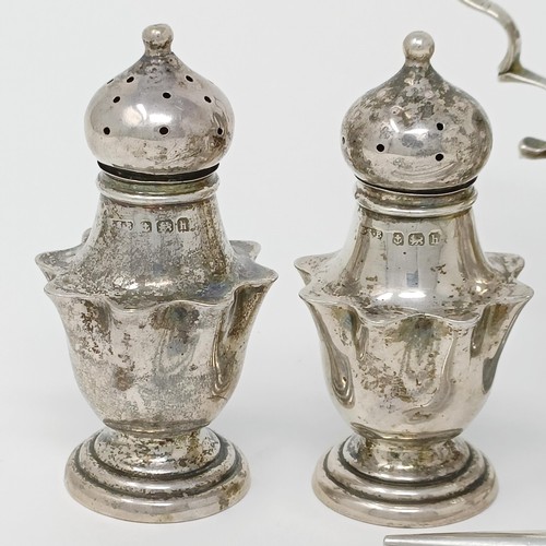 145 - A George III silver cream jug, a pair of peppers, a salt, with a blue glass liner, 4.9 ozt, two silv... 