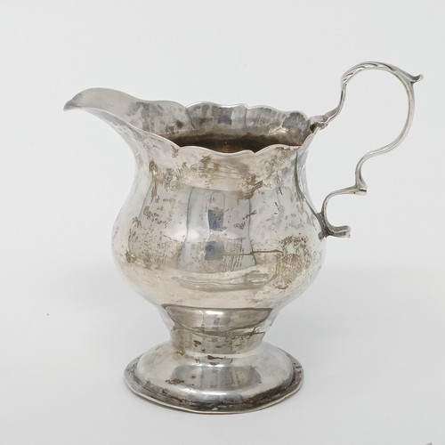 145 - A George III silver cream jug, a pair of peppers, a salt, with a blue glass liner, 4.9 ozt, two silv... 