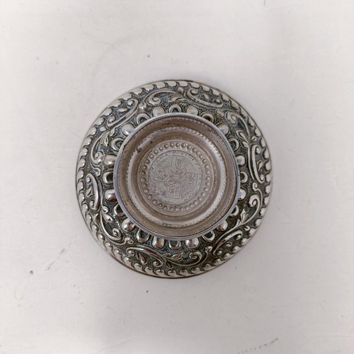 24 - An Elizabeth II silver and mahogany bottle coaster, a pierced silver bowl and bowl inset with a coin... 