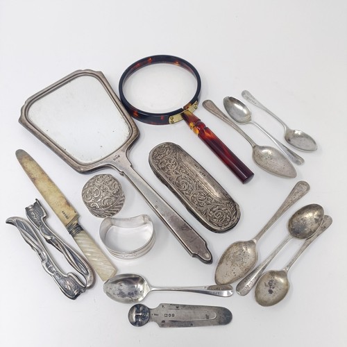 196 - A George V silver and blue enamel hand mirror, a tortoiseshell magnifying glass, a silver spectacles... 