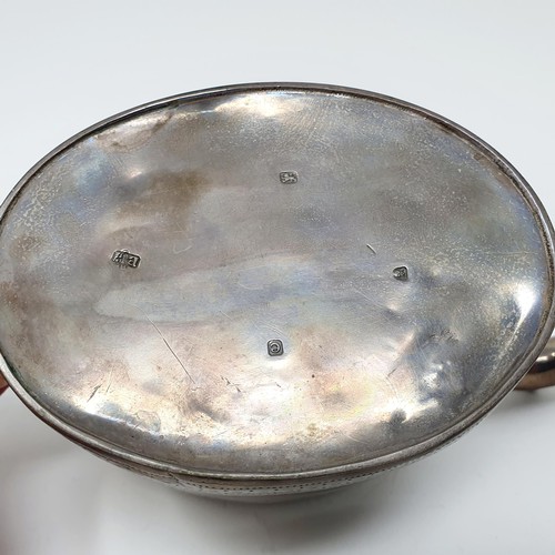 113A - A George III oval silver teapot, London 1820, all in 15.5 ozt