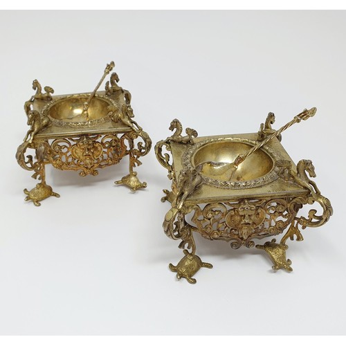 114B - A pair of Continental silver gilt salts, with pierced friezes, on scroll legs, to turtle feet, and m... 