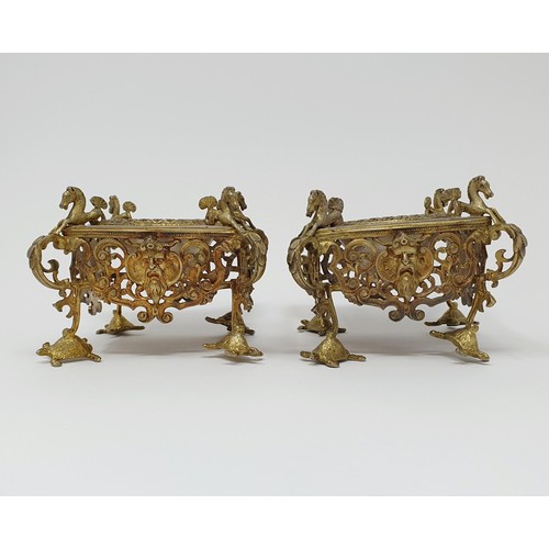 114B - A pair of Continental silver gilt salts, with pierced friezes, on scroll legs, to turtle feet, and m... 