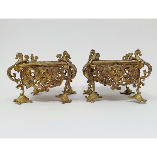 114B - A pair of Continental silver gilt salts, with pierced friezes, on scroll legs, to turtle feet, and m... 