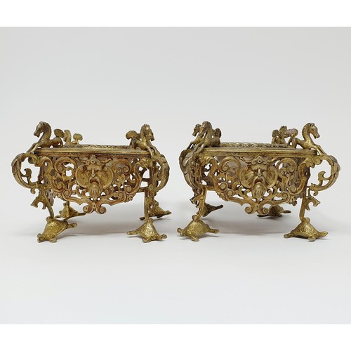 114B - A pair of Continental silver gilt salts, with pierced friezes, on scroll legs, to turtle feet, and m... 