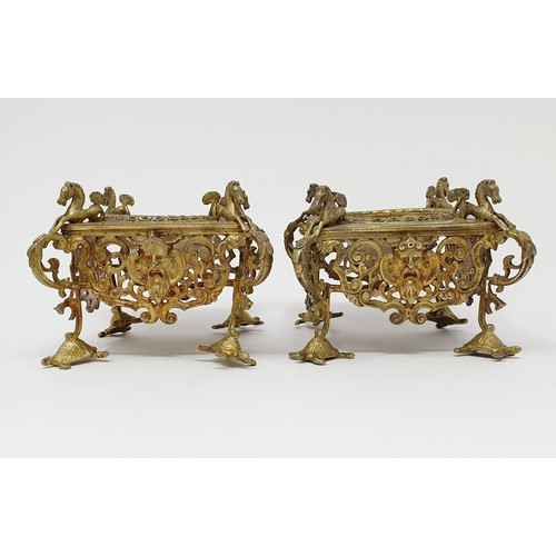 114B - A pair of Continental silver gilt salts, with pierced friezes, on scroll legs, to turtle feet, and m... 