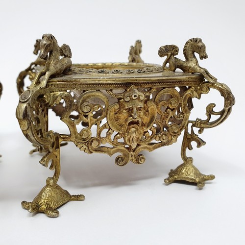 114B - A pair of Continental silver gilt salts, with pierced friezes, on scroll legs, to turtle feet, and m... 