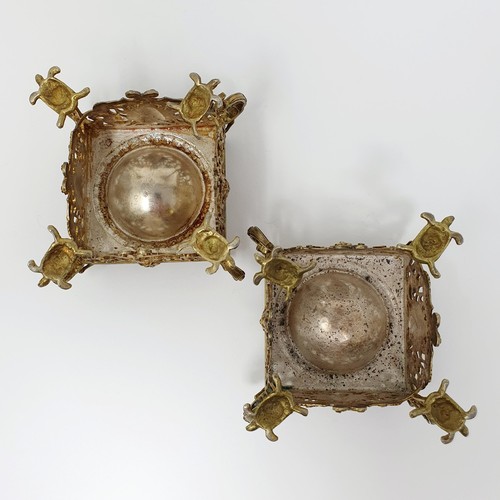 114B - A pair of Continental silver gilt salts, with pierced friezes, on scroll legs, to turtle feet, and m... 