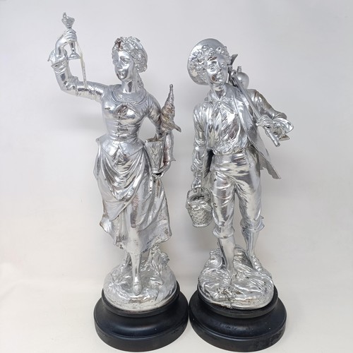 317 - A pair of silvered figures, representing wine, 47 cm, a silvered group of a Native American girl, wi... 