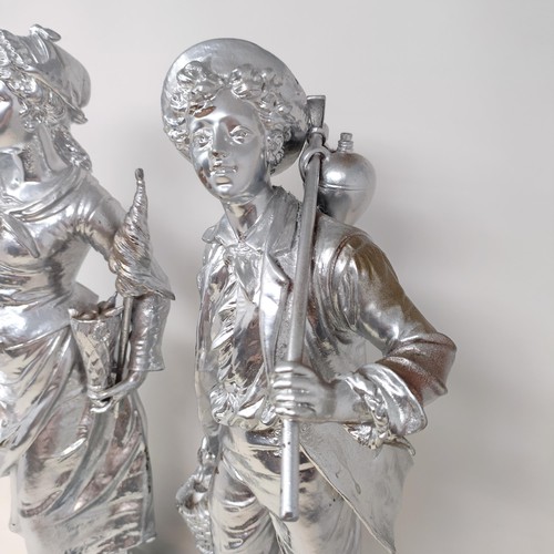 317 - A pair of silvered figures, representing wine, 47 cm, a silvered group of a Native American girl, wi... 