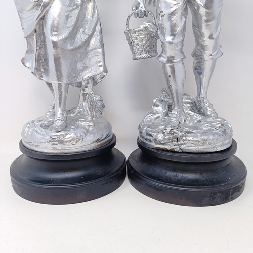 317 - A pair of silvered figures, representing wine, 47 cm, a silvered group of a Native American girl, wi... 