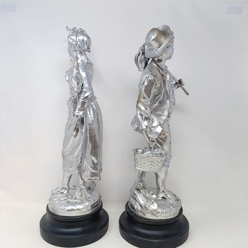 317 - A pair of silvered figures, representing wine, 47 cm, a silvered group of a Native American girl, wi... 