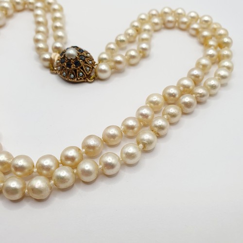 864 - A pearl double strand necklace, on a 9ct gold clasp