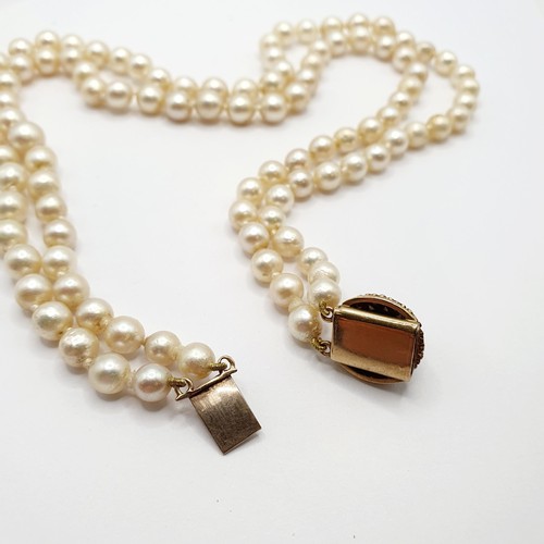 864 - A pearl double strand necklace, on a 9ct gold clasp