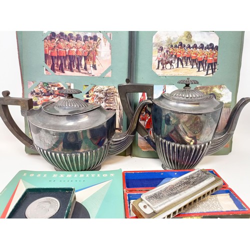 302 - An album of postcards, a silver plated coffee pot, a matching teapot, a 1951 Exhibition catalogue, a... 