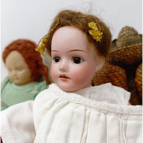 409 - A Heubach bisque headed doll, with a composite jointed body, other dolls and items (box)