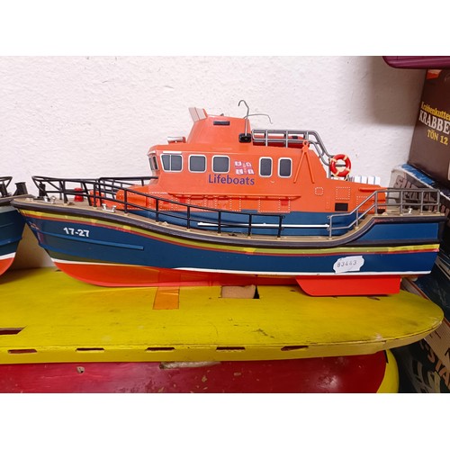 413 - A model of a Lifeboat, 46 cm wide, a boat model kit, two other model boats, and part of a model boat... 