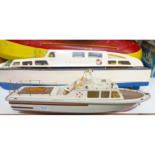 413 - A model of a Lifeboat, 46 cm wide, a boat model kit, two other model boats, and part of a model boat... 