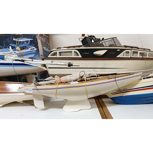 414 - A model boat, 29 cm wide, three model kits, boxed, and four other model boats (8)