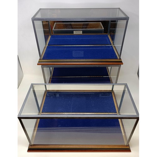 435 - Three mahogany wall hanging toy display cabinets, 58 cm wide, two others, and three table top displa... 