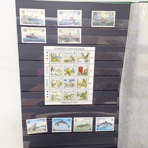 60 - A collection of Guernsey Mint commemorative stamps, in thirteen small Guernsey Post albums, and two ... 