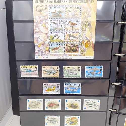 60 - A collection of Guernsey Mint commemorative stamps, in thirteen small Guernsey Post albums, and two ... 