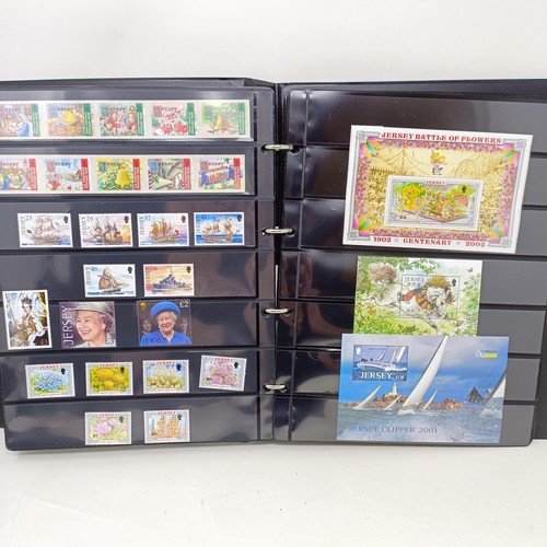 60 - A collection of Guernsey Mint commemorative stamps, in thirteen small Guernsey Post albums, and two ... 