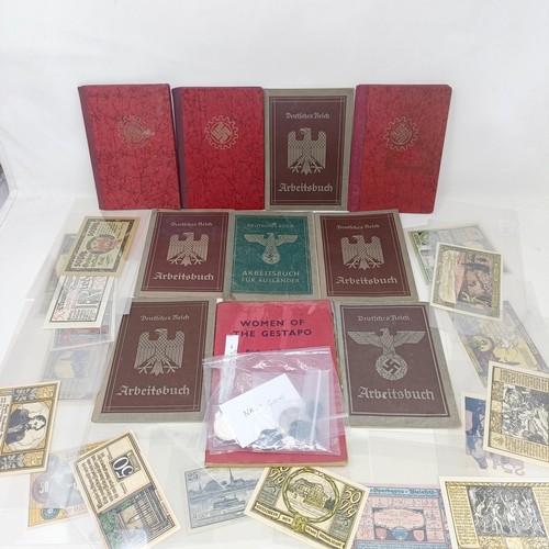 228 - A group of nine German pay books, another booklet, a group of German Third Reich coins, and assorted... 