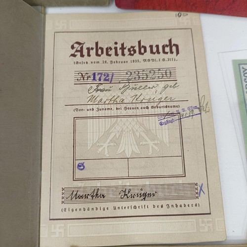 228 - A group of nine German pay books, another booklet, a group of German Third Reich coins, and assorted... 