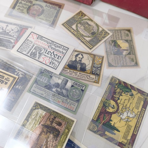 228 - A group of nine German pay books, another booklet, a group of German Third Reich coins, and assorted... 