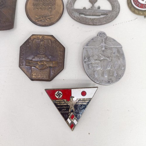 229 - A group of assorted German items, including a WWII 1939 German and Japanese Alliance buttonhole badg... 