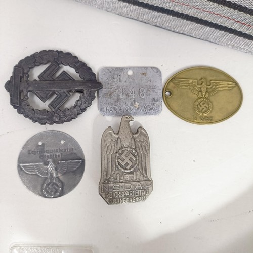 232 - A group of assorted German items, including two WWI wound badges, and a NSDAP Nuremburg rally badge,... 