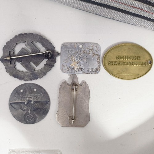 232 - A group of assorted German items, including two WWI wound badges, and a NSDAP Nuremburg rally badge,... 