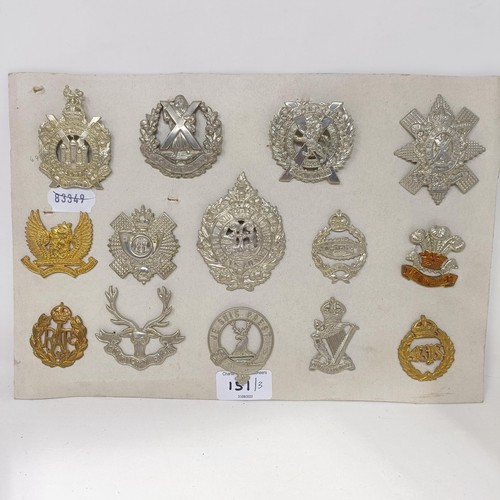 151 - A group of assorted military badges, mounted on three cards