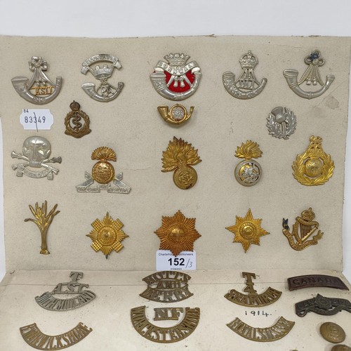 152 - A group of assorted shoulder titles, buttons and military badges, on three cards