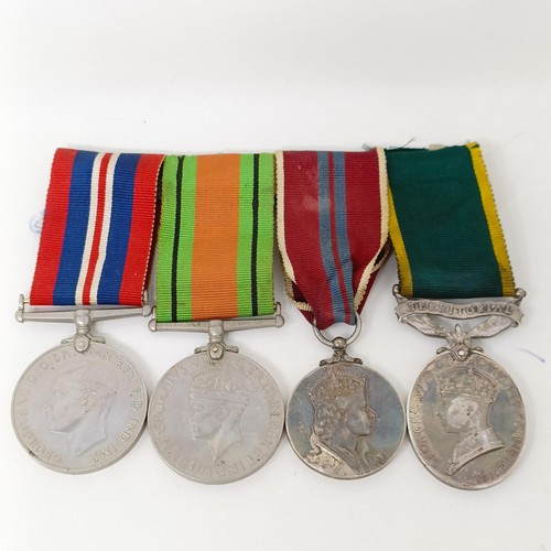 243 - A group of four medals, comprising a Defence Medal, a War Medal, a Queen Elizabeth II Coronation Med... 