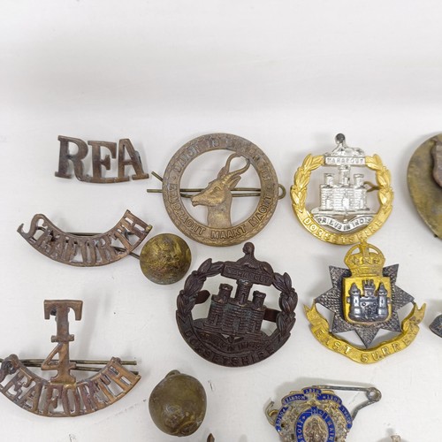 245 - Assorted military badges, shoulder titles and other items