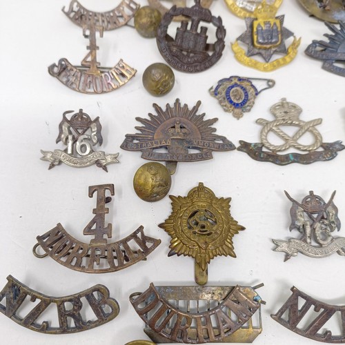 245 - Assorted military badges, shoulder titles and other items