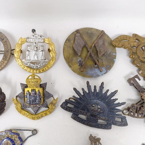 245 - Assorted military badges, shoulder titles and other items