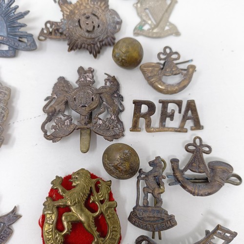 245 - Assorted military badges, shoulder titles and other items