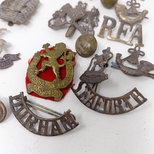 245 - Assorted military badges, shoulder titles and other items