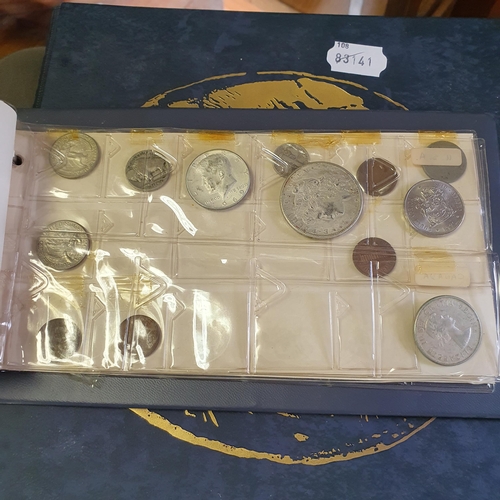 90 - A George IV crown, 1821, an USA Liberty dollar, 1921, and other coins, in two albums