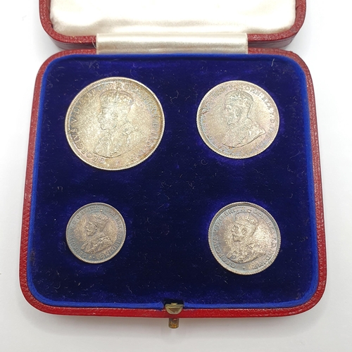 147 - A set of four British West Africa coins, 2 shillings - 3 pence, 1913, in its original leather mounte... 