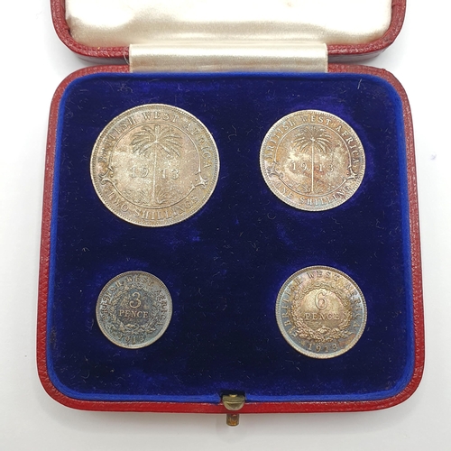 147 - A set of four British West Africa coins, 2 shillings - 3 pence, 1913, in its original leather mounte... 