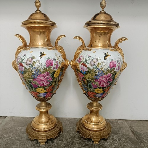 300 - A large pair Continental porcelain vases and covers, decorated birds and flowers, with gilt handles ... 