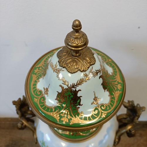 301 - A Continental porcelain vase and cover, decorated a ruin, with gilt metal mounts, 74 cm high