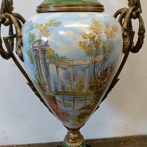 301 - A Continental porcelain vase and cover, decorated a ruin, with gilt metal mounts, 74 cm high