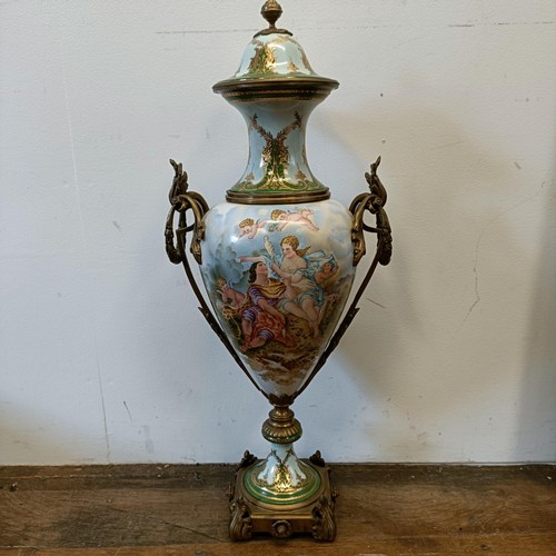 301 - A Continental porcelain vase and cover, decorated a ruin, with gilt metal mounts, 74 cm high