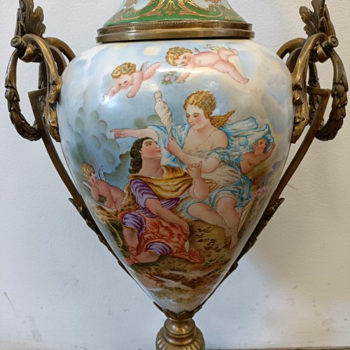 301 - A Continental porcelain vase and cover, decorated a ruin, with gilt metal mounts, 74 cm high