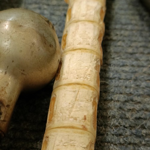 334 - A walking stick made from a vertebrae, other walking, shooting sticks and items (qty)